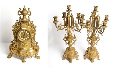 Lot 332 - A modern gilt-metal striking mantle clock and a six light candelabra garniture (3)