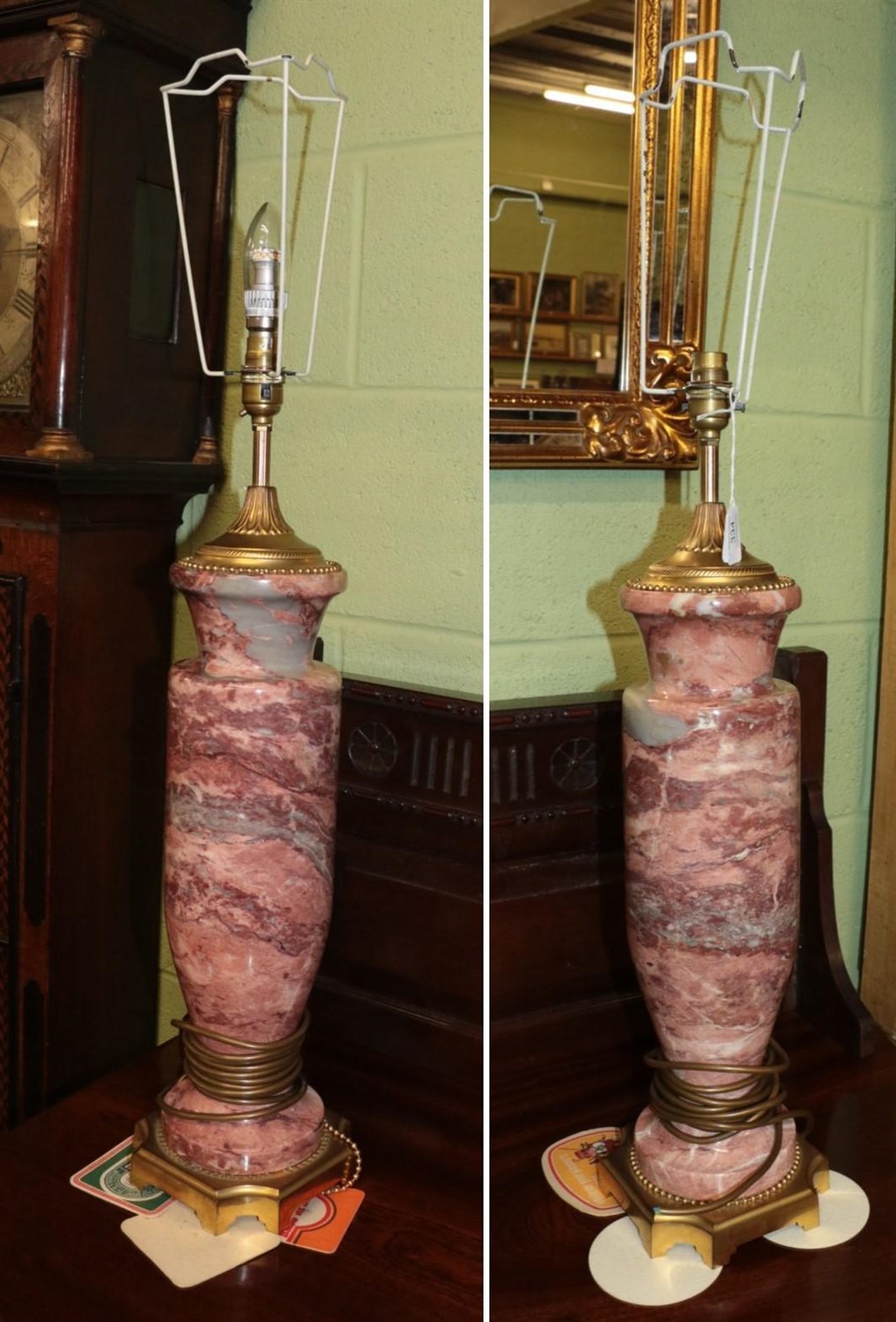 Lot 334 - A pair of pink marble lamps