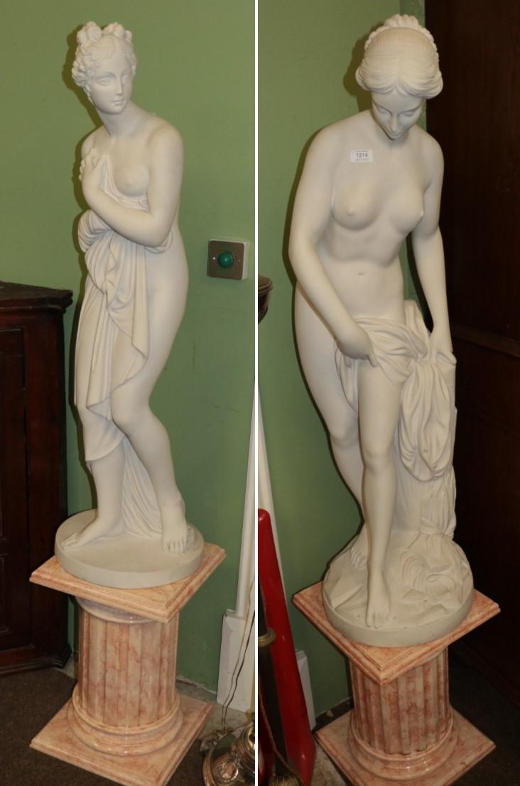 Lot 1214 - Two large bisque style figures of maidens on faux pink marble bases