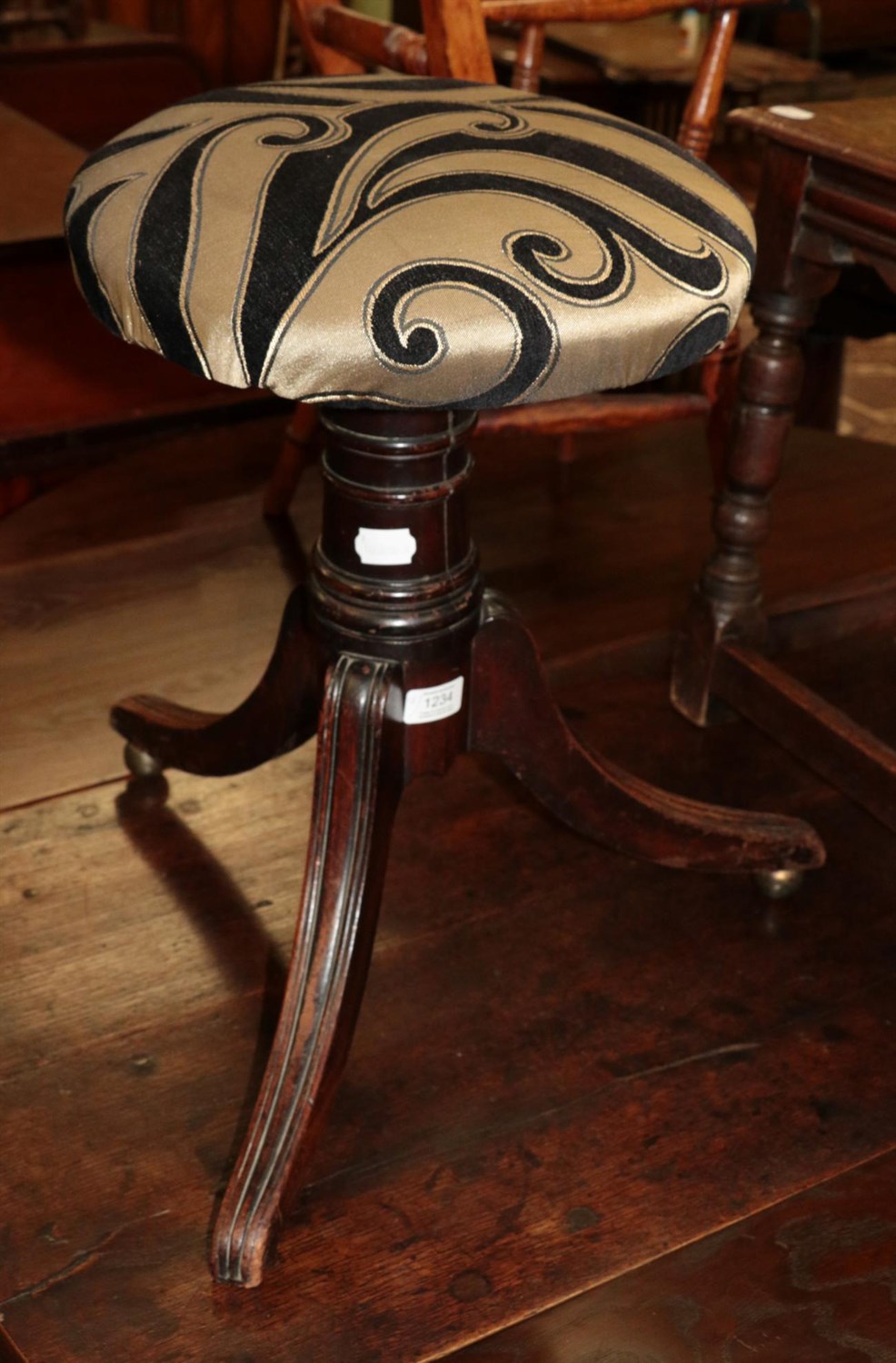 Lot 1234 - An Indian carpet runner and a 19th century adjustable revolving music stool (2)