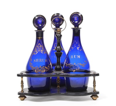 Lot 8 - A Set of Three Blue Glass Mallet Decanters and Stoppers, circa 1790, gilt with scroll and...