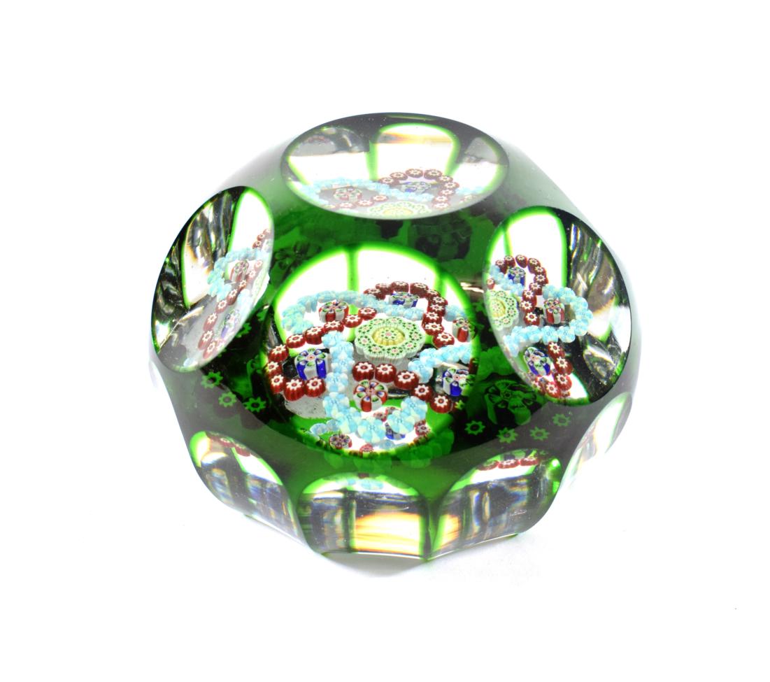 Lot 19 - A Baccarat Faceted Translucent Green Overlay Garland Paperweight, circa 1850, set with two...
