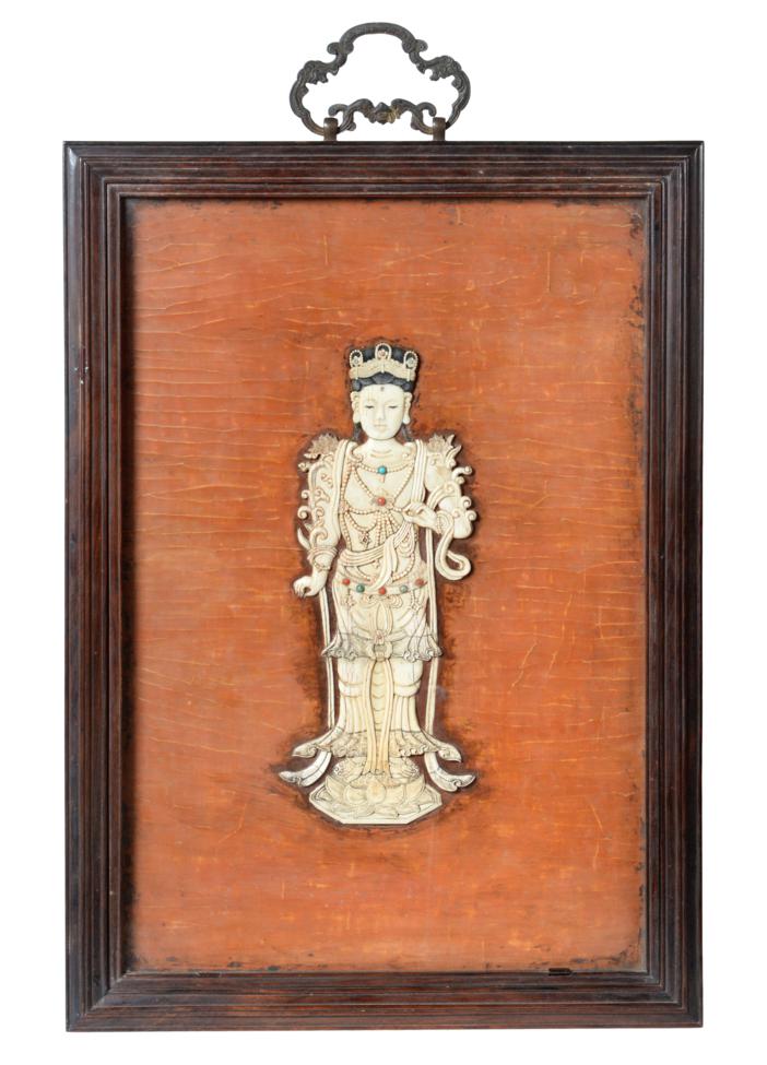 Lot 65 - A Chinese Ivory Plaque, Qing Dynasty, 19th century, carved in low relief as a maiden standing...