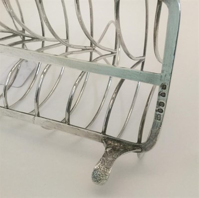 Lot 86 - A George III Silver Toastrack, by Solomon Hougham, London, 1799, oblong and with seven bars and...
