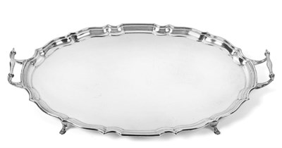Lot 157 - A George V Silver Tray, by Barker Brothers, Chester, 1919, shaped oval and on four pad feet,...