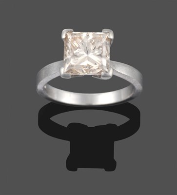 Lot 217 - A Platinum Diamond Solitaire Ring, the princess cut diamond in a four claw setting to knife...