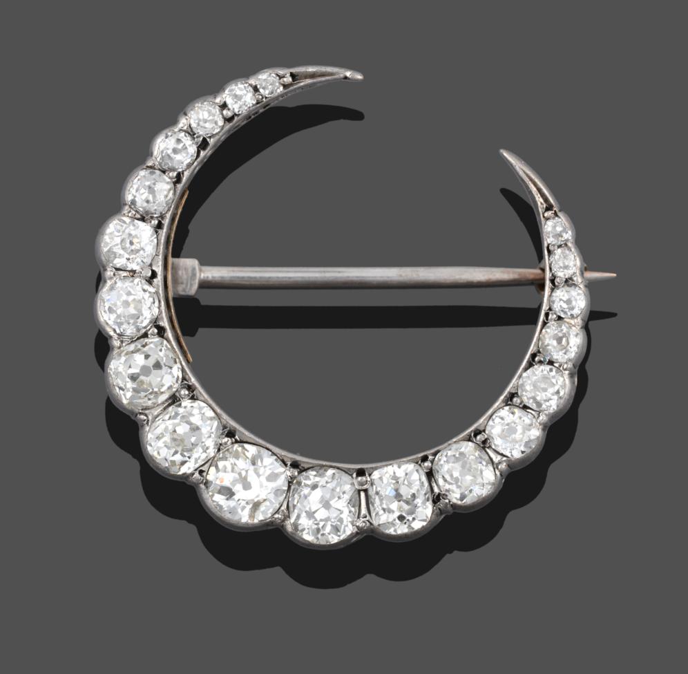 Lot 218 - A Diamond Crescent Brooch, set throughout with graduated old cut diamonds in white claw...
