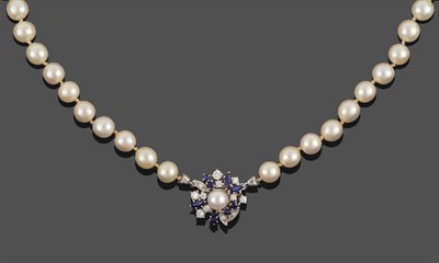 Lot 236 - A Cultured Pearl Necklace, eighty-two cultured pearls knotted to a sapphire and diamond cluster...