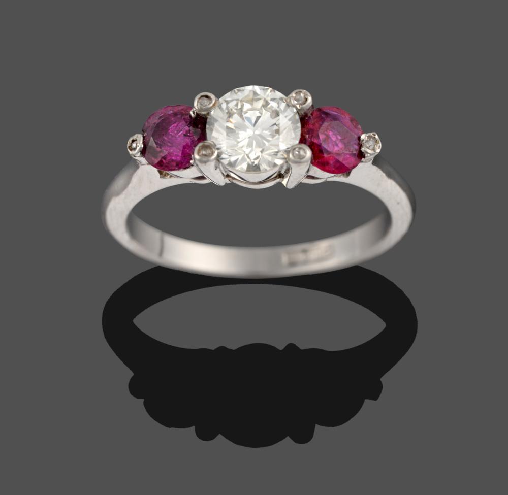 Lot 241 - A Ruby and Diamond Three Stone Ring, a round brilliant cut diamond between two round cut rubies, in