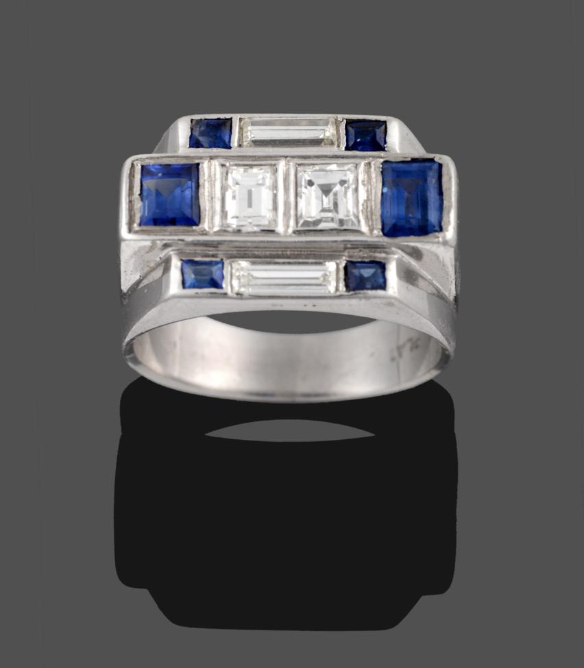 Lot 242 - An Art Deco Style Diamond and Sapphire Ring, comprised of three geometric stepped rows, the central