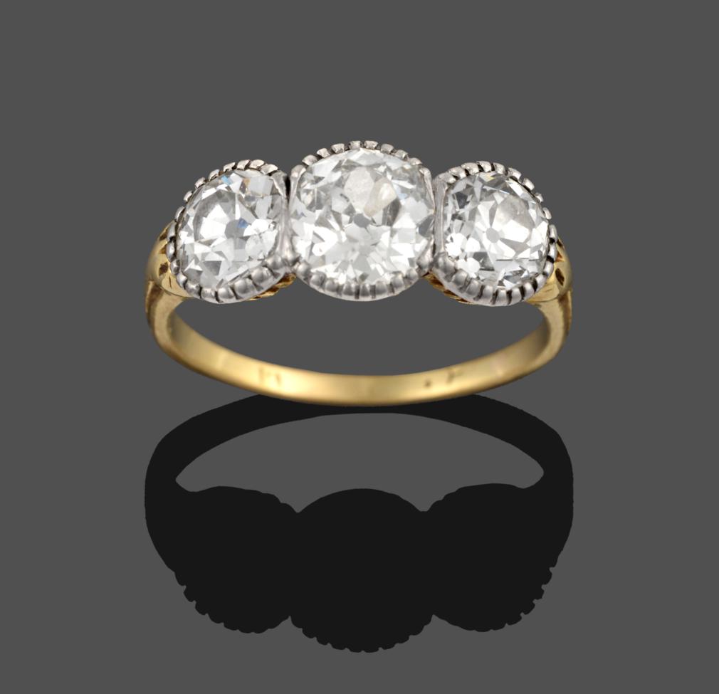 Lot 249 - An Early 20th Century Diamond Three Stone Ring, the graduated old cut diamonds in white fronted...