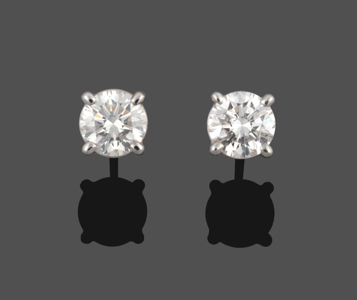Lot 259 - A Pair of 18 Carat Gold Diamond Solitaire Earrings, the round brilliant cut diamonds in white...