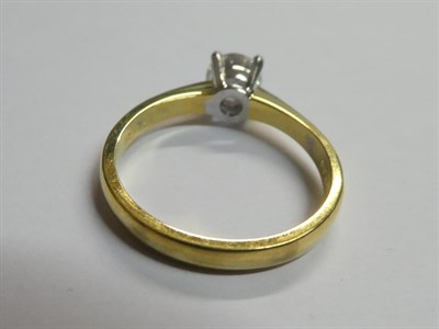 Lot 260 - An 18 Carat Gold Diamond Solitaire Ring, the round brilliant cut diamond in a white four claw...