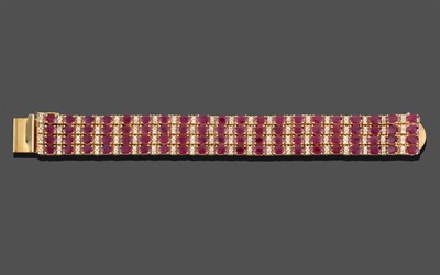 Lot 263 - A Ruby and Diamond Bracelet, four rows of oval cut rubies alternating with pairs of round brilliant