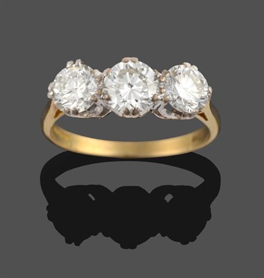 Lot 264 - An 18 Carat Gold Diamond Three Stone Ring, the round brilliant cut diamonds in double white...