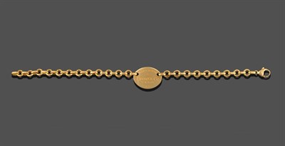 Lot 267 - An 18 Carat Gold Bracelet, by Tiffany & Co., a trace link chain with a central oval plaque engraved
