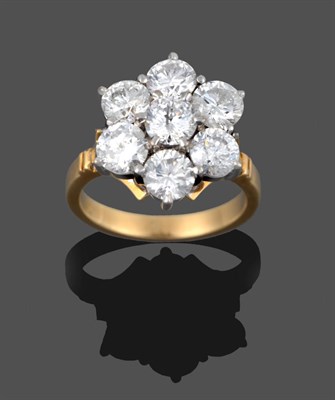 Lot 274 - A Diamond Cluster Ring, seven round brilliant cut diamonds in white claw settings, to a yellow...