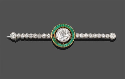 Lot 288 - A Diamond and Emerald Bar Brooch, an old cut diamond in a white millegrain setting, spaced to a...