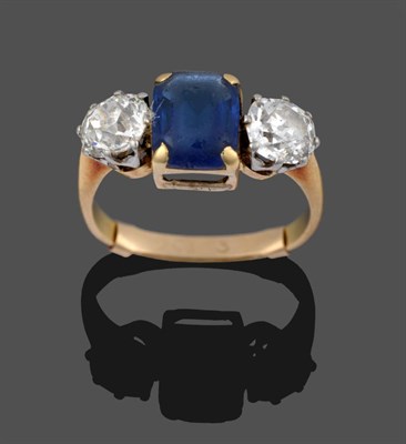 Lot 289 - A Sapphire and Diamond Three Stone Ring, the emerald-cut sapphire in yellow claw settings,...