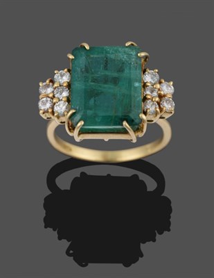 Lot 291 - An Emerald and Diamond Ring, the emerald-cut emerald flanked by five round brilliant cut...