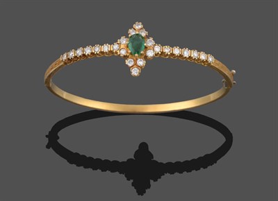 Lot 293 - An Emerald and Diamond Set Bangle, an oval mixed-cut emerald within a border of round brilliant cut