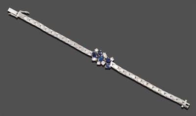 Lot 297 - A Sapphire and Diamond Bracelet, an abstract cluster of five pear cut sapphires, two marquise...