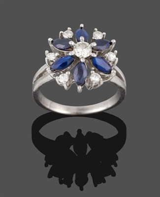 Lot 299 - A Sapphire and Diamond Cluster Ring, a round brilliant cut diamond centres a cluster of six...