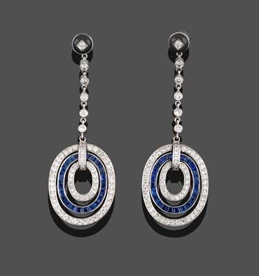 Lot 300 - A Pair of Sapphire and Diamond Drop Earrings, a diamond and onyx stud suspends chain linked...
