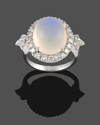 Lot 302 - An 18 Carat White Gold Moonstone and Diamond Ring, a cabochon moonstone within a border of...