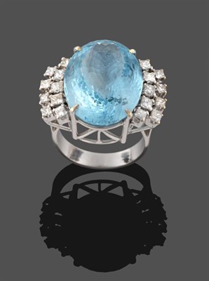 Lot 304 - An Aquamarine and Diamond Ring, the oval cut aquamarine in a white four claw setting, with nine...