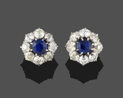 Lot 305 - A Pair of Sapphire and Diamond Cluster Stud Earrings, each comprises an oval mixed cut sapphire...