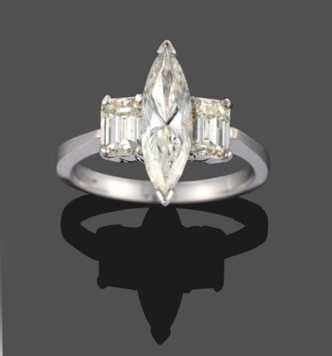 Lot 319 - An 18 Carat White Gold Diamond Three Stone Ring, a marquise cut diamond centrally with an...