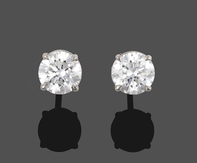 Lot 322 - A Pair of Diamond Solitaire Stud Earrings, the round brilliant cut diamonds in white four claw...