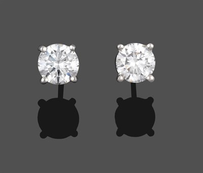 Lot 330 - A Pair of Diamond Solitaire Stud Earrings, the round brilliant cut diamonds in white four claw...