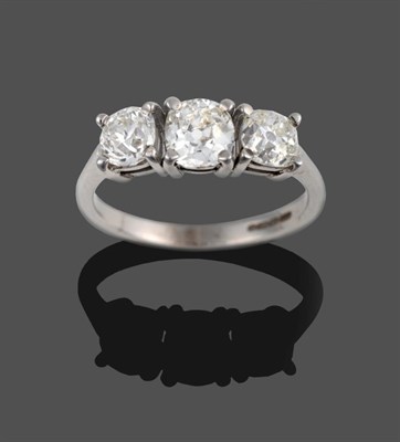 Lot 339 - An 18 Carat White Gold Diamond Three Stone Ring, the graduated old cut diamonds in claw...