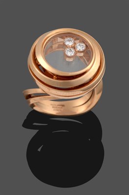 Lot 350 - An 18 Carat Rose Gold ''Happy Emotions'' Ring, by Chopard, three collet set 'floating' round...