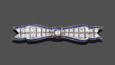 Lot 359 - An Art Deco Diamond and Sapphire Bow Brooch, two rows of graduated diamonds bordered by...