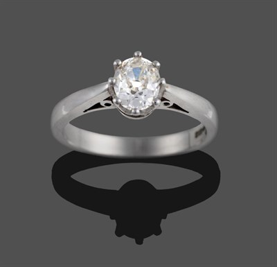 Lot 365 - An 18 Carat White Gold Diamond Solitaire Ring, the oval old cut diamond in a claw setting, to a...