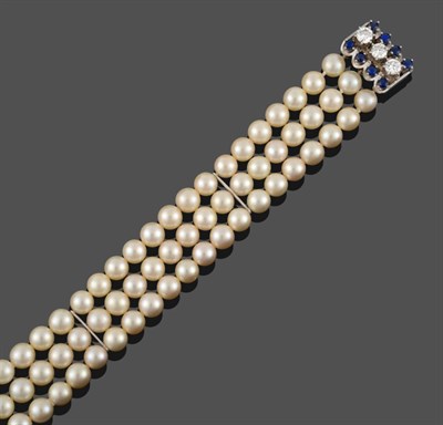 Lot 373 - A Cultured Pearl Bracelet with a Sapphire and Diamond Set Clasp, three rows of twenty-two...
