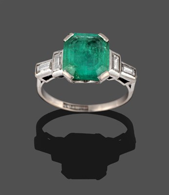 Lot 377 - A Mid 20th Century Emerald and Diamond Ring, the emerald-cut emerald in a white corner claw...