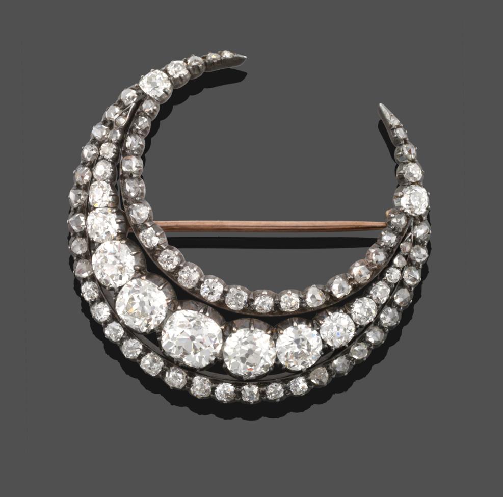 Lot 378 - A Victorian Diamond Crescent Brooch, a row of graduated old cut diamonds within two rows of smaller