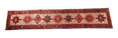 Lot 613 - Heriz Runner Iranian Azerbaijan, circa 1960 The ivory field with a column of stepped and hooked...