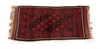 Lot 618 - Baluch Rug North East Khorasan, circa 1900 The honeycomb lattice field enclosed by madder...