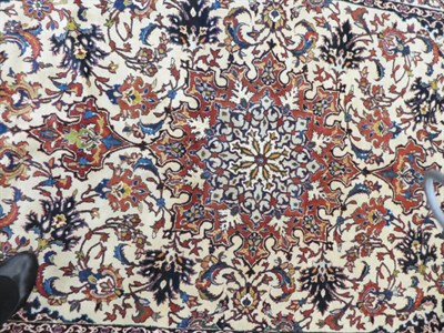 Lot 630 - Finely Woven Isfahan Rug Central Iran, circa 1940 The cream field richly decorated with vines...