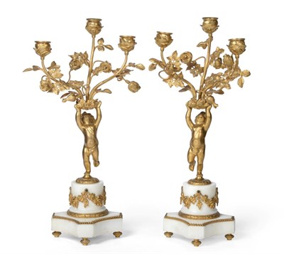 Lot 648 - A Pair of French Gilt Metal Mounted White Marble Candelabra, in Louis XVI style, each as a...