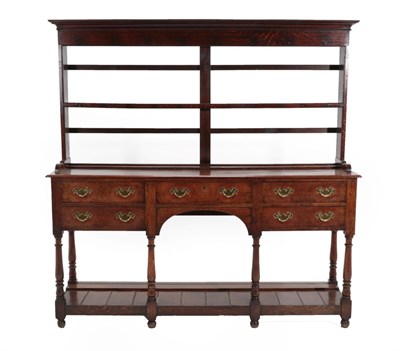 Lot 652 - A George III Oak Open Dresser, late 18th century, the rack with moulded pediment above a shelf, the