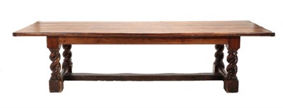 Lot 662 - A Substantial Stained Pine Rectangular Refectory Dining Table, the four plank top with cleated ends
