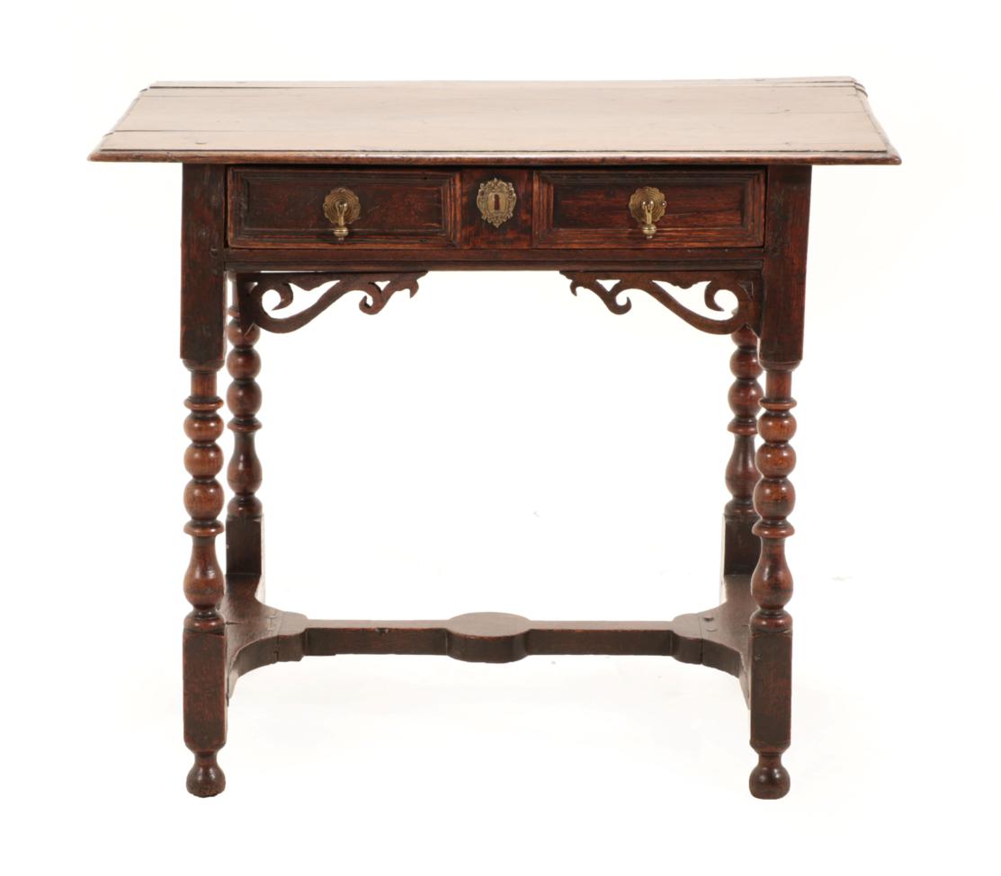 Lot 672 - A Late 17th Century Joined Oak Table, the moulded top above a two-as-one moulded drawer above...
