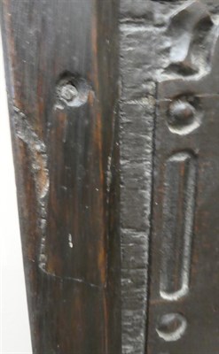 Lot 679 - An Early 18th Century Joined Oak Settle, the back support with four carved panels with five moulded
