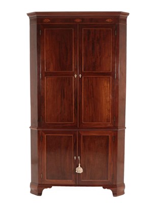 Lot 692 - A George III Mahogany and Boxwood Strung Free-Standing Corner Cupboard, late 18th century, the...